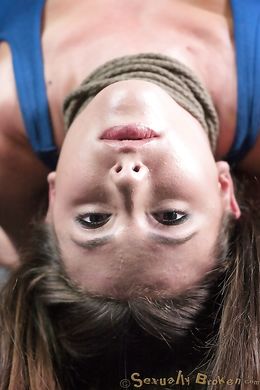 Lass hangs upside down and submissive sucks her master