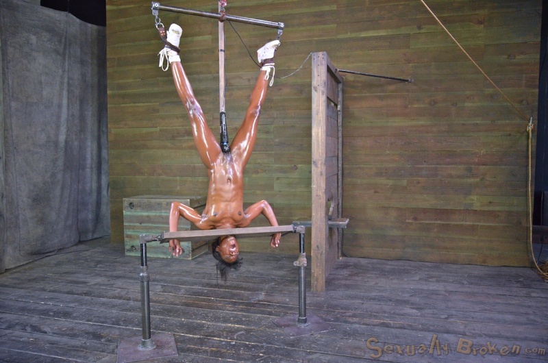 Suspended athletic ebony with a white dick in the mouth